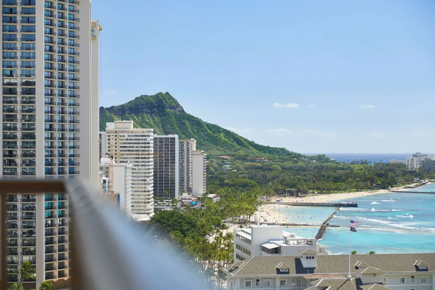 Diamond Head and beach view beyond a balcony at OUTRIGGER Waikiki Beachcomber Hotel.