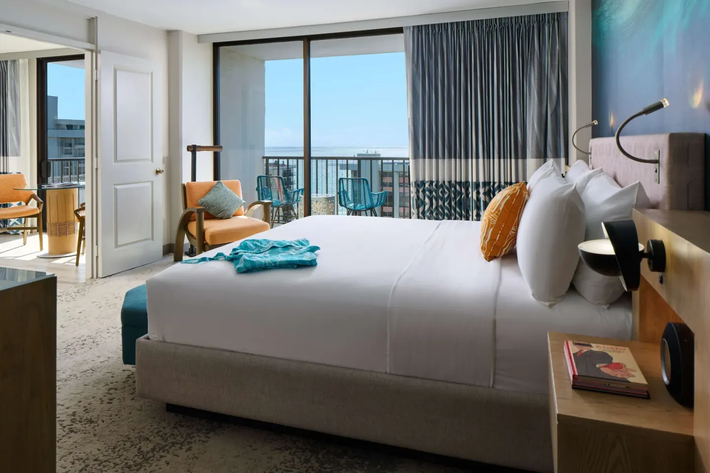 King bedroom with balcony seating and ocean view at OUTRIGGER Waikiki Beachcomber Hotel.