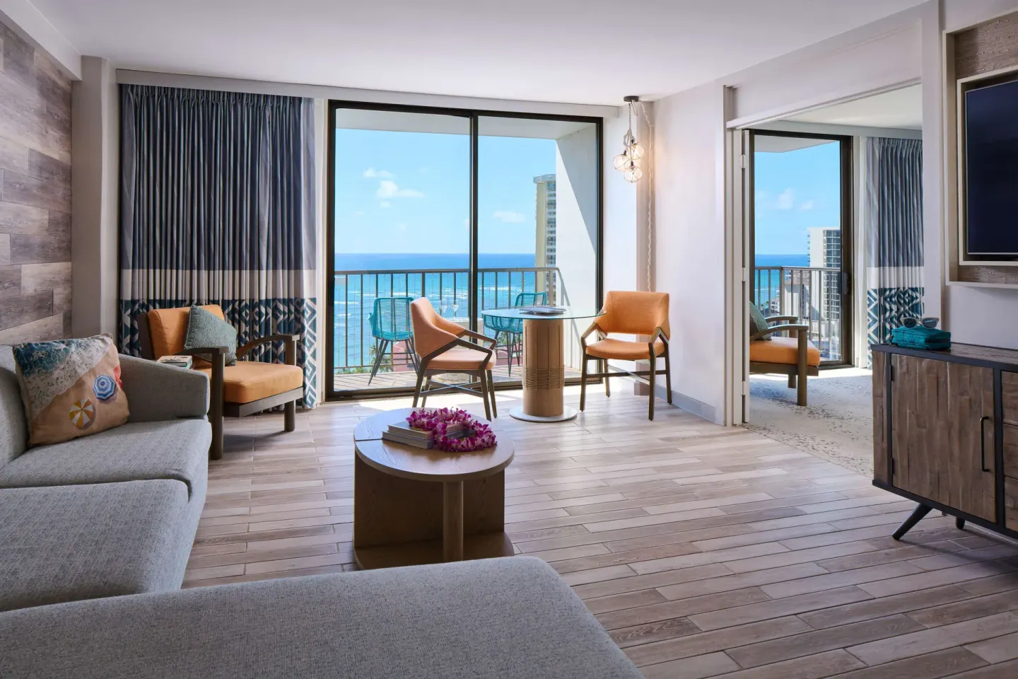 Suite living room with balcony ocean view at OUTRIGGER Waikiki Beachcomber Hotel.