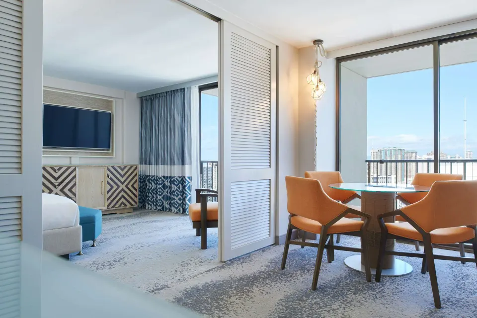 Ocean View Suite dining nook and bedroom at OUTRIGGER Waikiki Beachcomber Hotel.