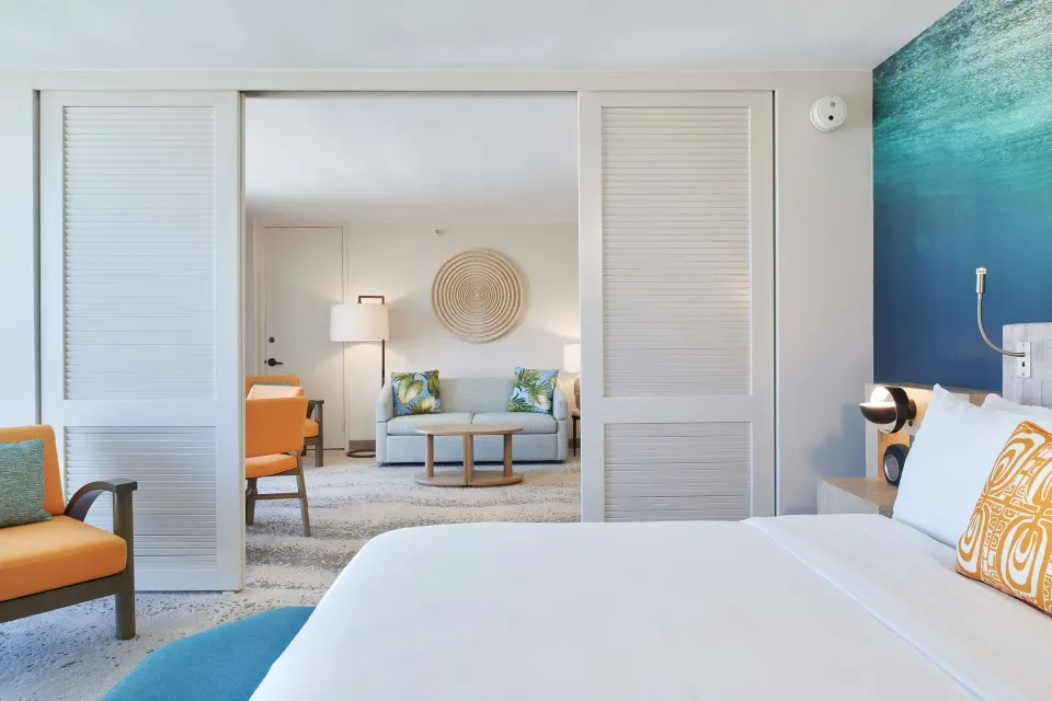 Ocean View Suite king bed and sitting room at OUTRIGGER Waikiki Beachcomber Hotel.
