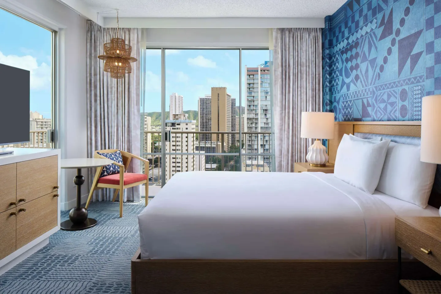 King guest room with city-view windows at OUTRIGGER Waikiki Paradise Hotel.
