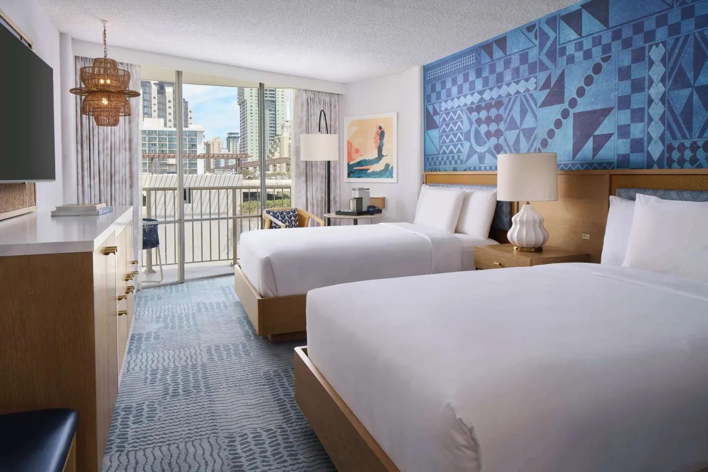 Two-bed guest room with balcony and city view at OUTRIGGER Waikiki Paradise Hotel.