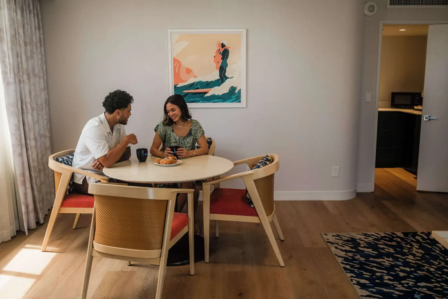Couple dining at an in-room table at OUTRIGGER Waikiki Paradise Hotel.