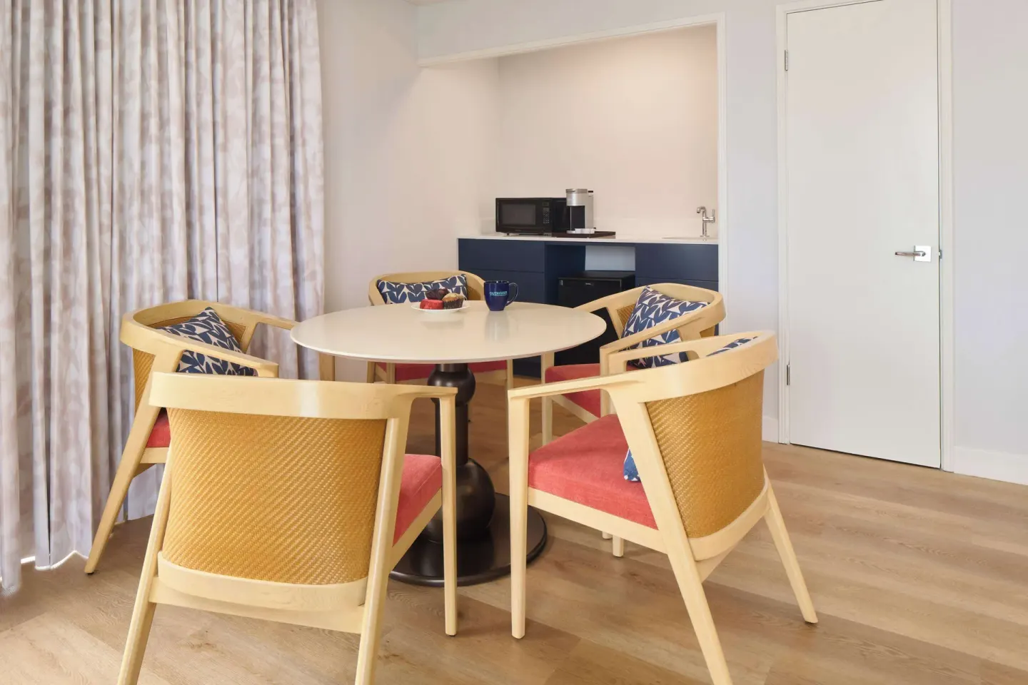 Guest room dining table and kitchenette at OUTRIGGER Waikiki Paradise Hotel.