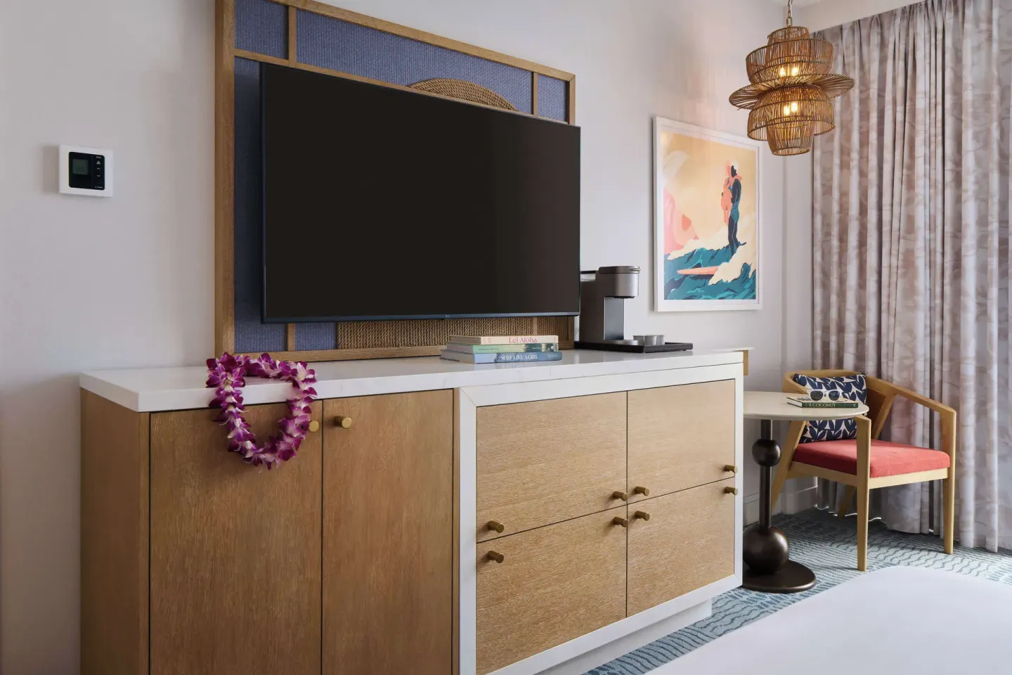 Guest room dresser, TV, coffee maker, and chair at OUTRIGGER Waikiki Paradise Hotel.