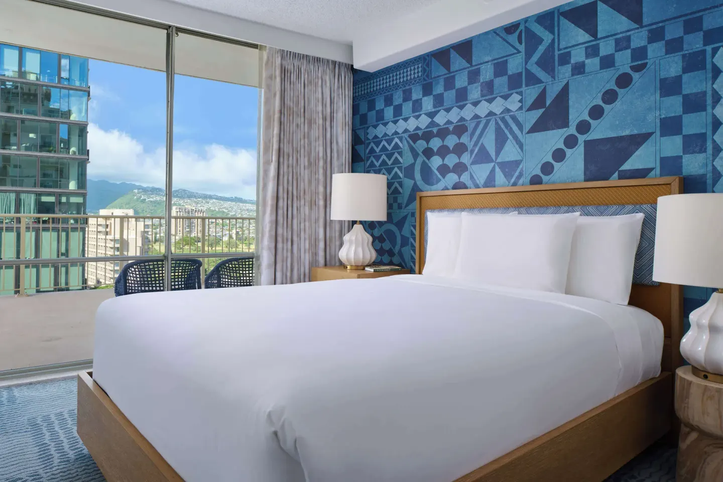 King-bed guest room with balcony and mountain view at OUTRIGGER Waikiki Paradise Hotel.