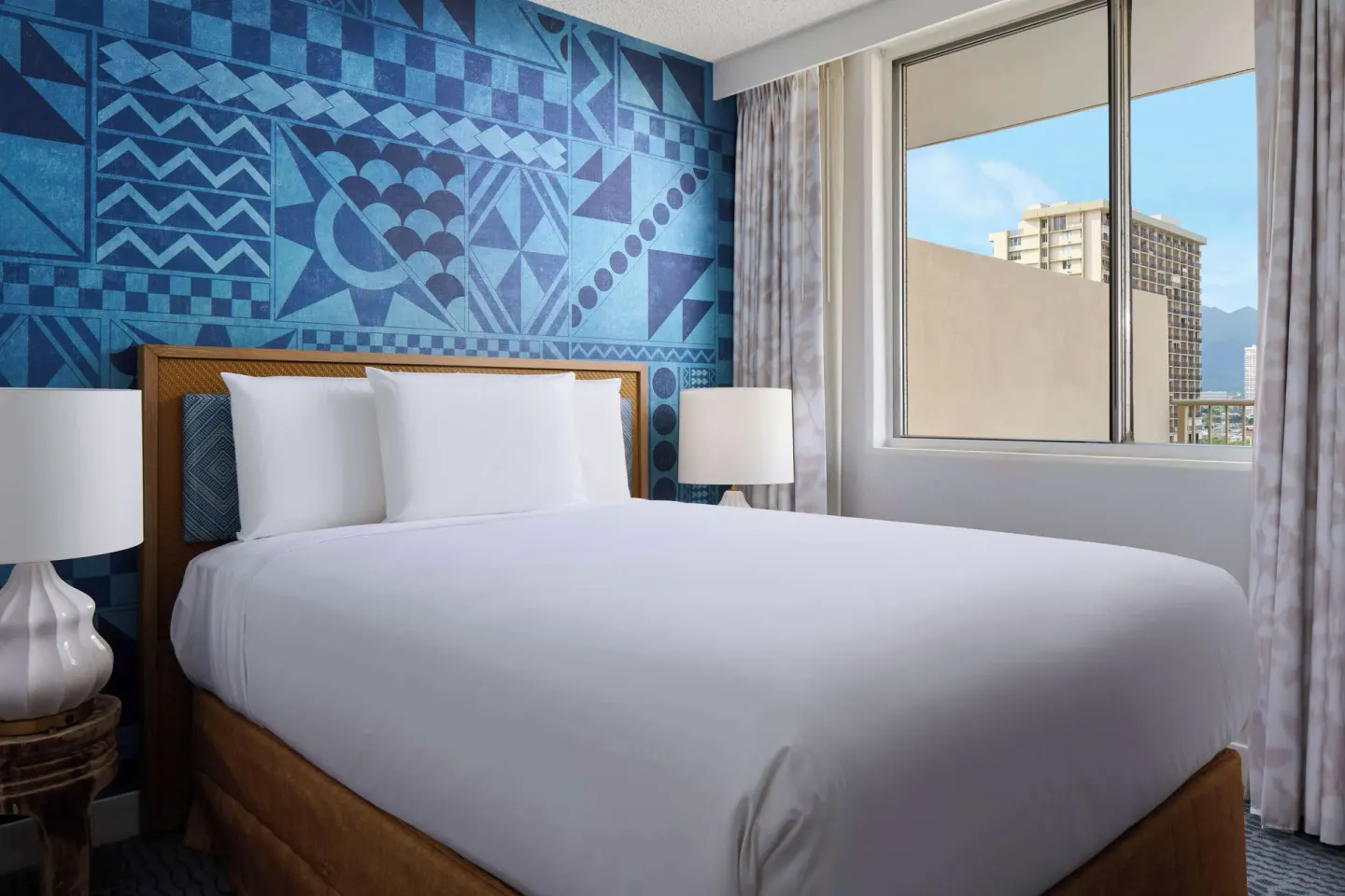 King-bed guest room with side window at OUTRIGGER Waikiki Paradise Hotel.