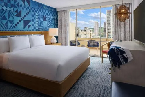 King bedroom in a 1 Bedroom Suite Partial Ocean View at OUTRIGGER Waikiki Paradise Hotel.
