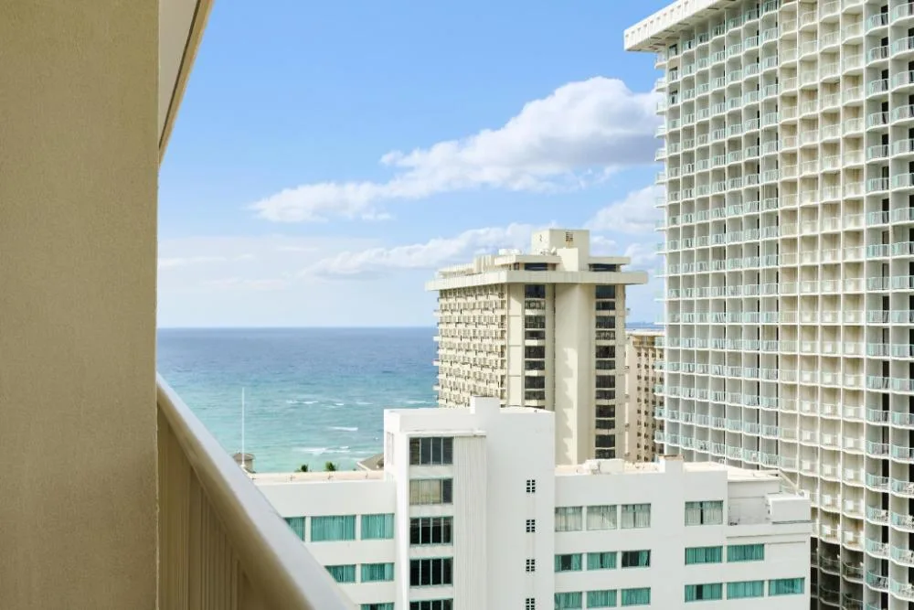 Ocean and city view from a suite balcony at OUTRIGGER Waikiki Paradise Hotel.