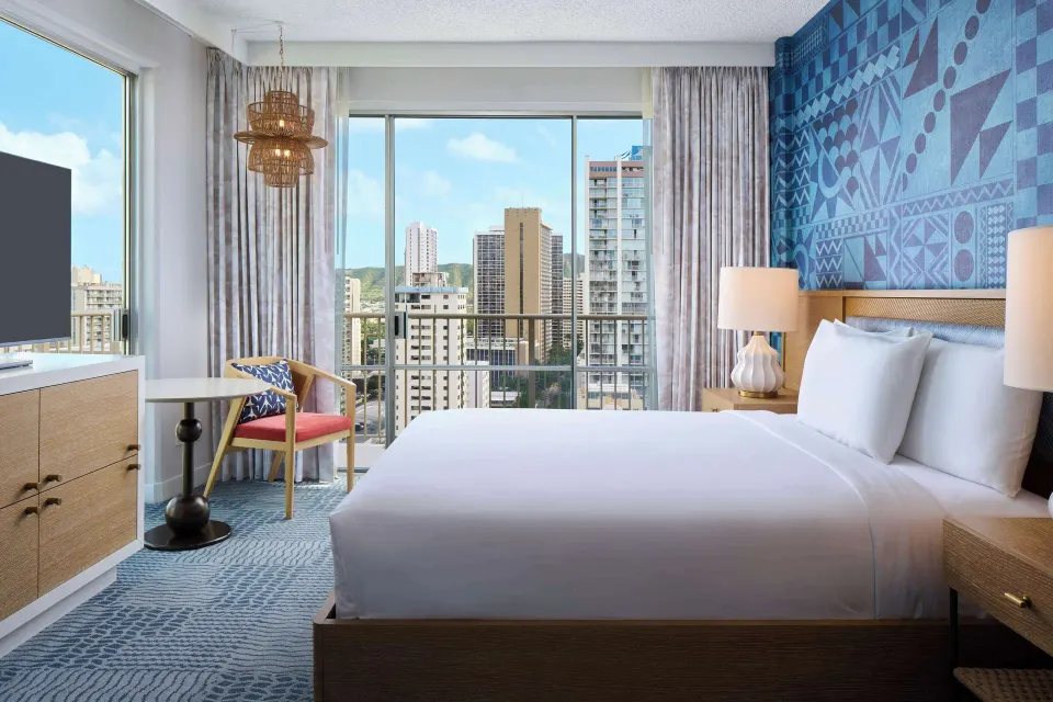 Waikiki view king room with balcony windows at OUTRIGGER Waikiki Paradise Hotel.