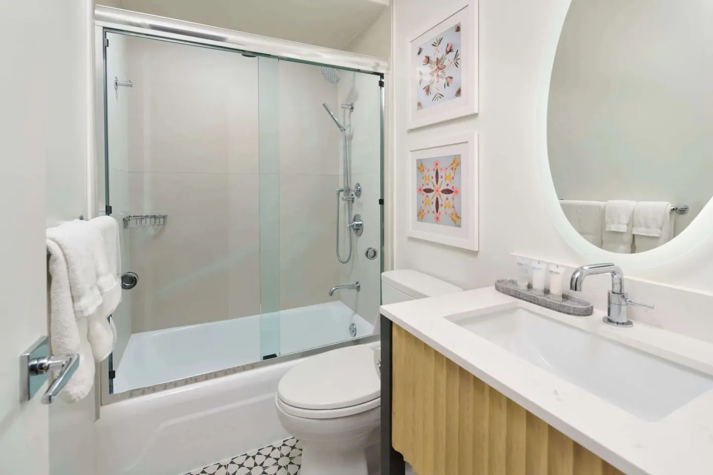 Guest room bathroom with tub, glass shower screen and vanity at OUTRIGGER Waikiki Paradise Hotel.