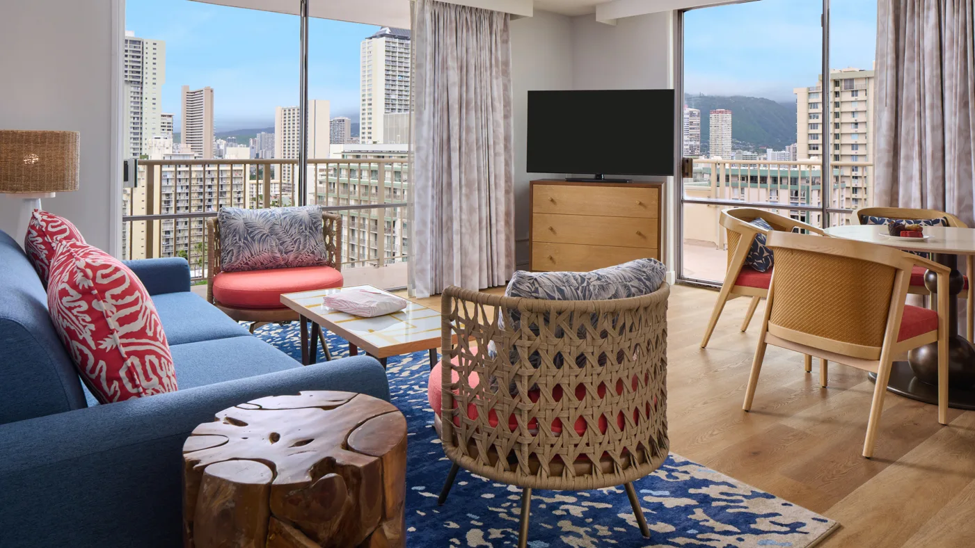 Standard Room seating area and balcony city views at OUTRIGGER Waikiki Paradise Hotel.