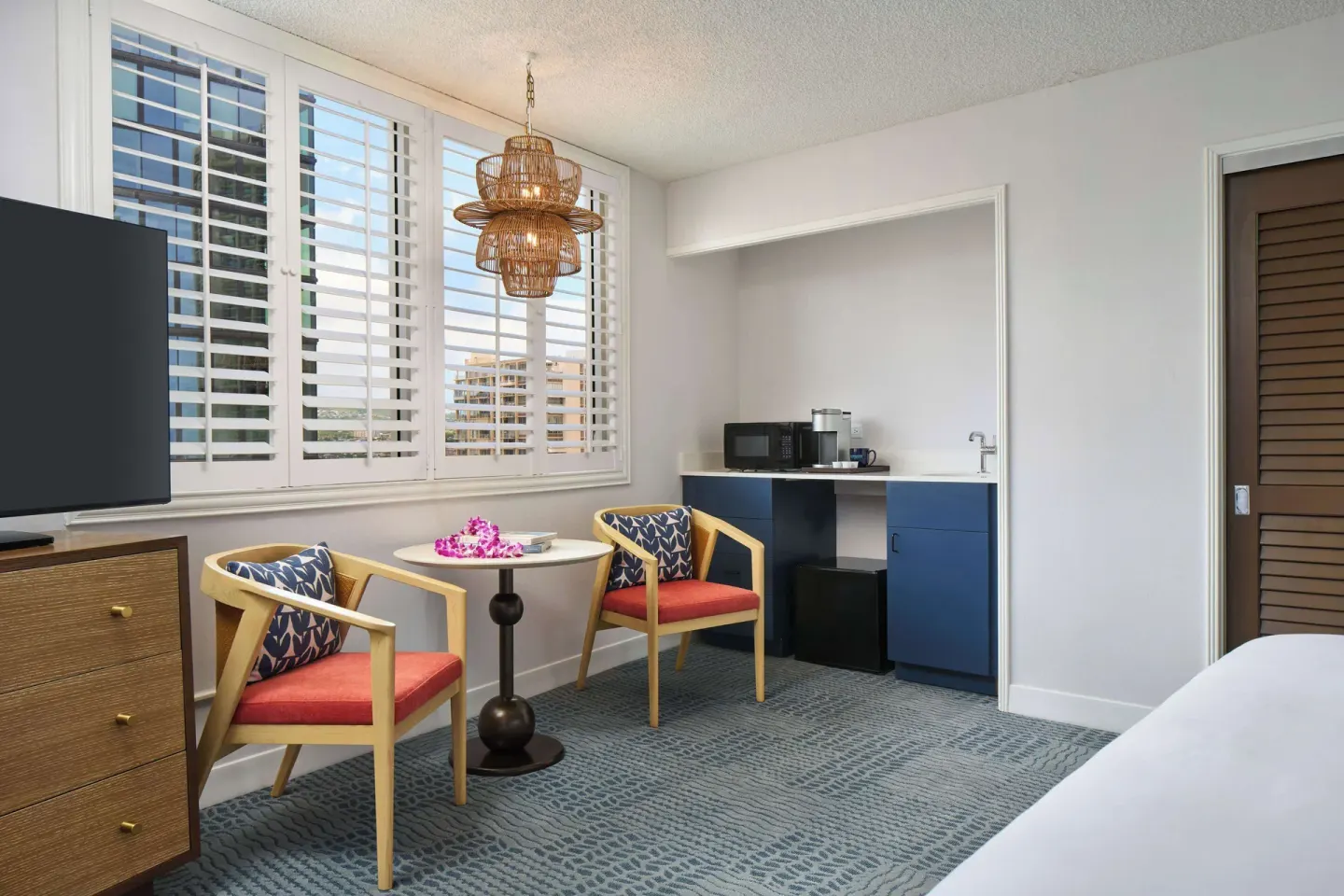 Studio seating area and kitchenette at OUTRIGGER Waikiki Paradise Hotel.