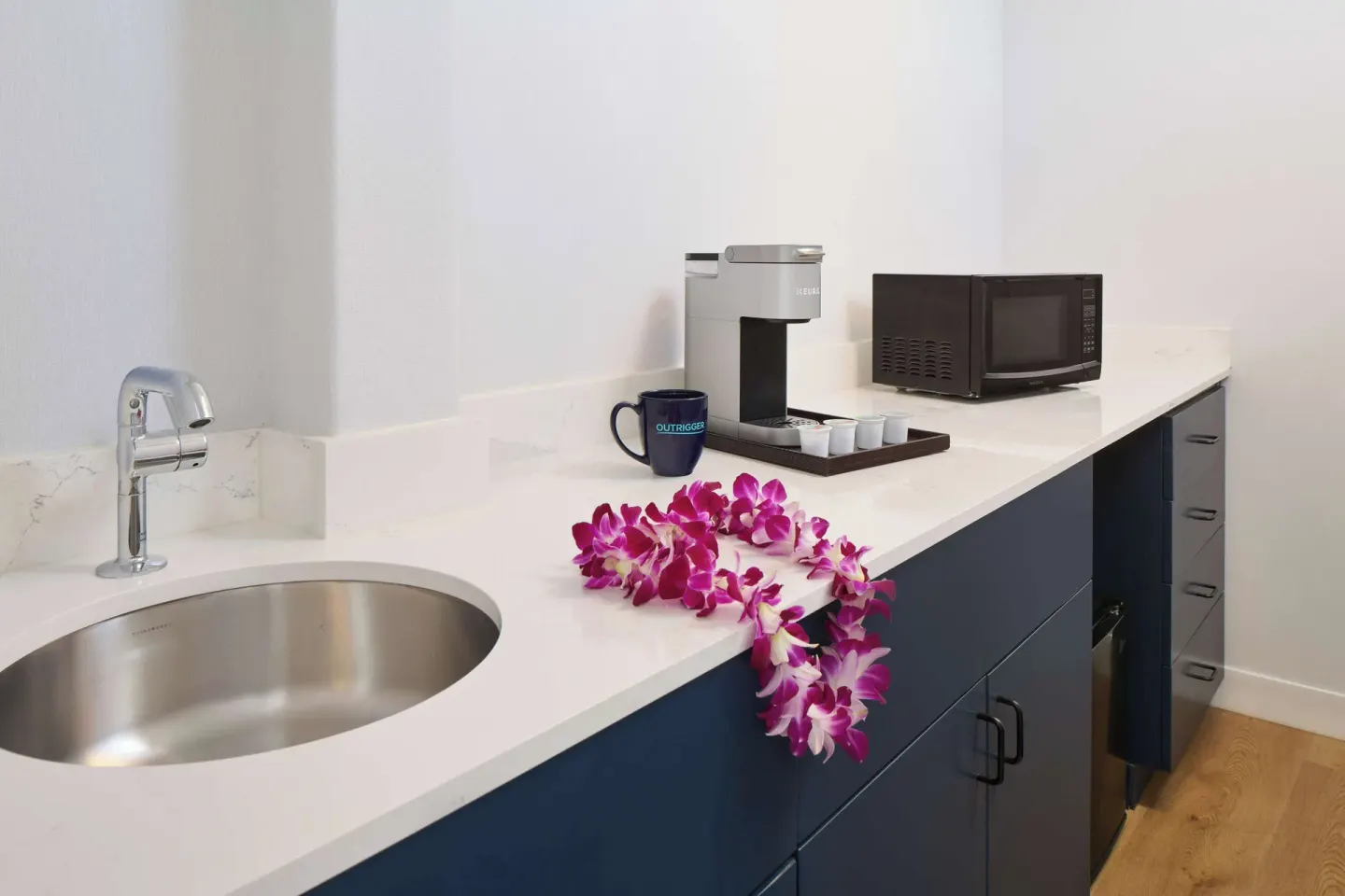 Studio counter with sink, coffee maker, and microwave at OUTRIGGER Waikiki Paradise Hotel.
