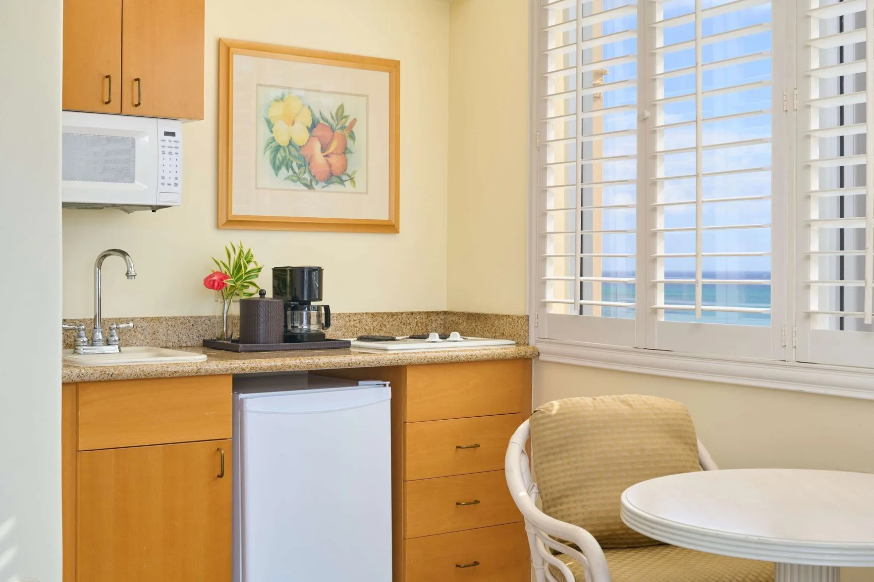 Two Studio with Kitchenette counter at OUTRIGGER Waikiki Paradise Hotel with mini fridge and shutters.