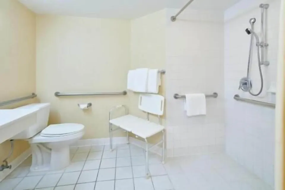 Waikiki Suite View accessible bathroom with roll-in shower at OUTRIGGER Waikiki Paradise Hotel.