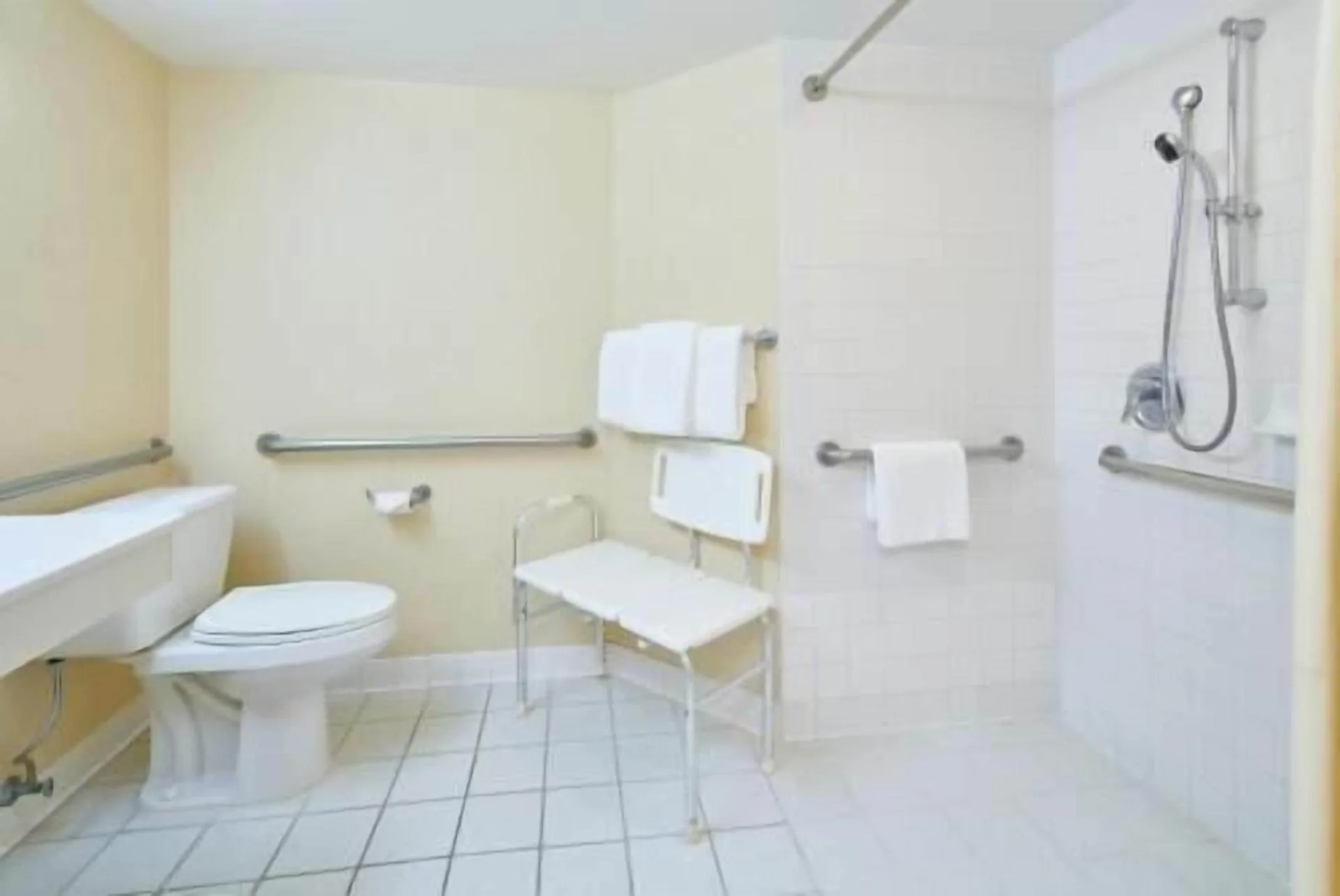 Waikiki Suite View accessible bathroom with roll-in shower at OUTRIGGER Waikiki Paradise Hotel.