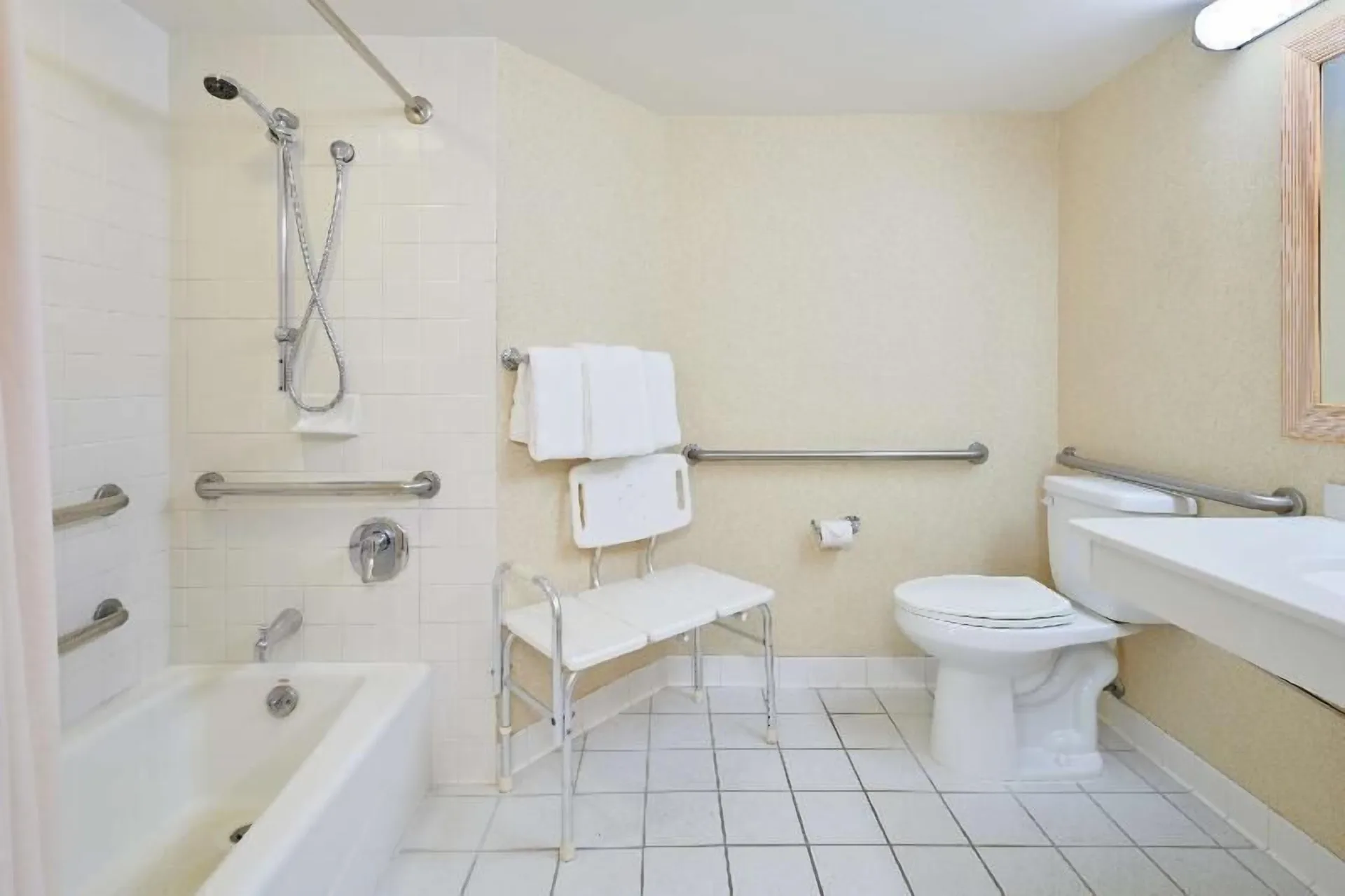 Waikiki Suite View accessible bathroom with tub and grab bars at OUTRIGGER Waikiki Paradise Hotel.