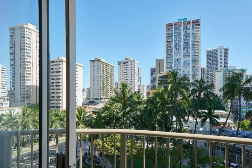Balcony view of palms and Waikiki high-rises from OUTRIGGER Waikiki Paradise Hotel.