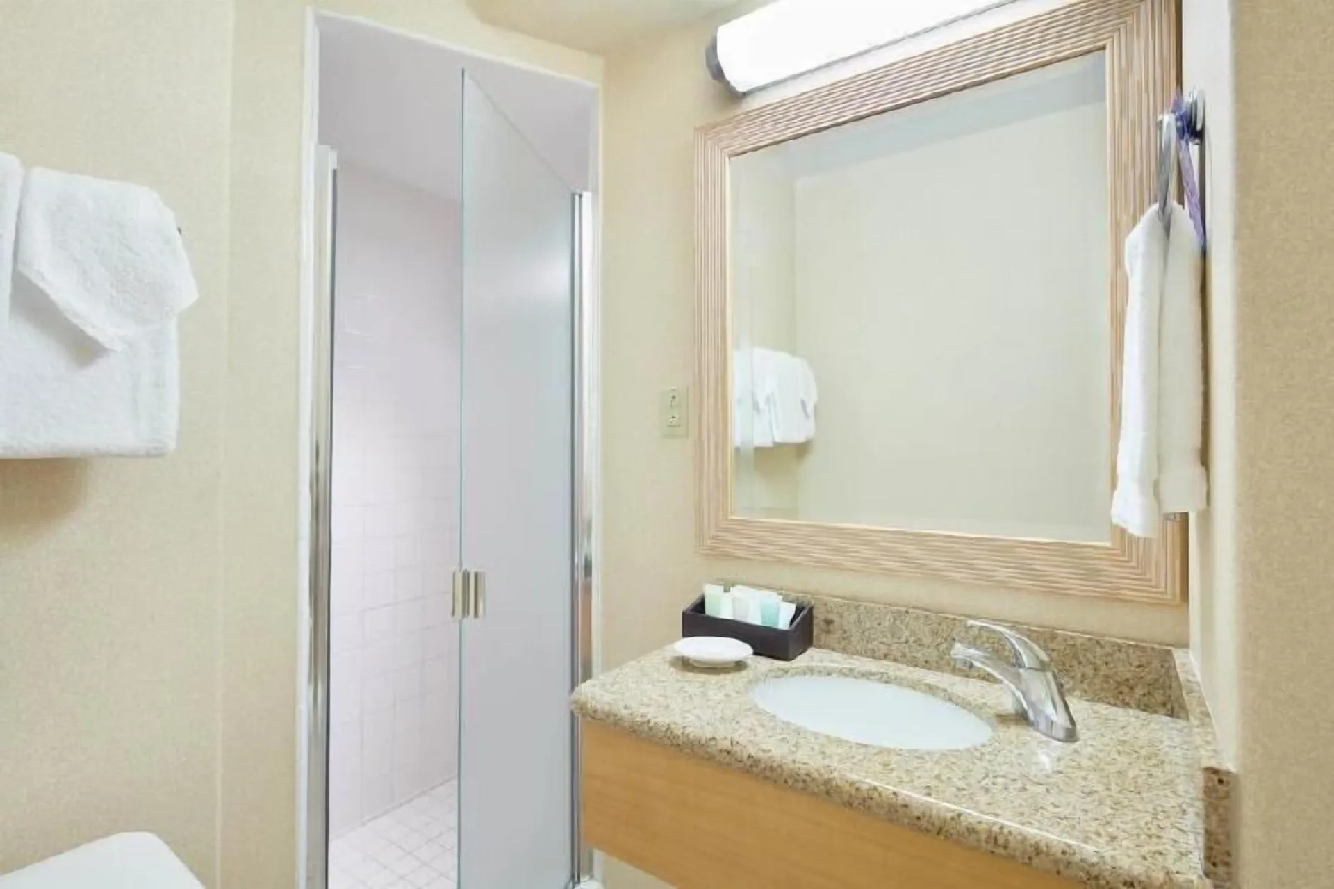 Waikiki Suite View bathroom vanity and shower entry at OUTRIGGER Waikiki Paradise Hotel.