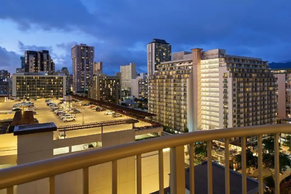 Evening city view from a Waikiki Suite balcony at OUTRIGGER Waikiki Paradise Hotel.
