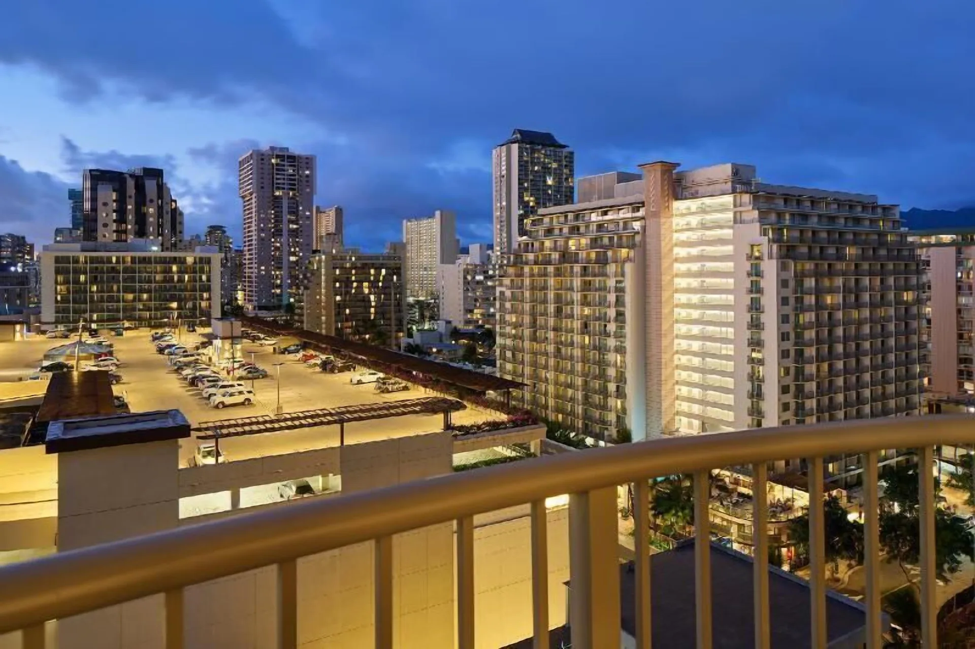 Evening city view from a Waikiki Suite balcony at OUTRIGGER Waikiki Paradise Hotel.