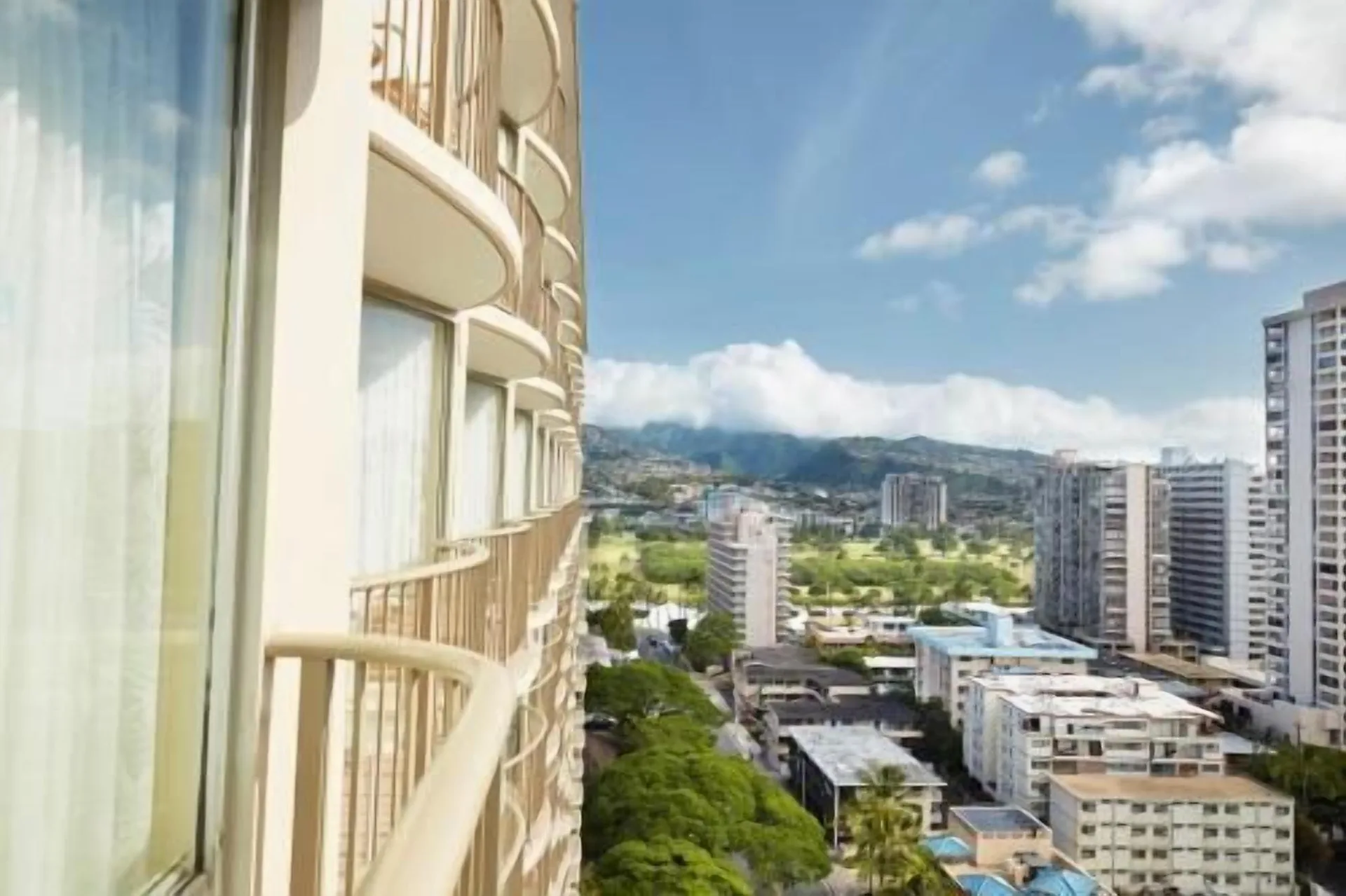 Balcony view of neighboring towers and mountains from OUTRIGGER Waikiki Paradise Hotel.