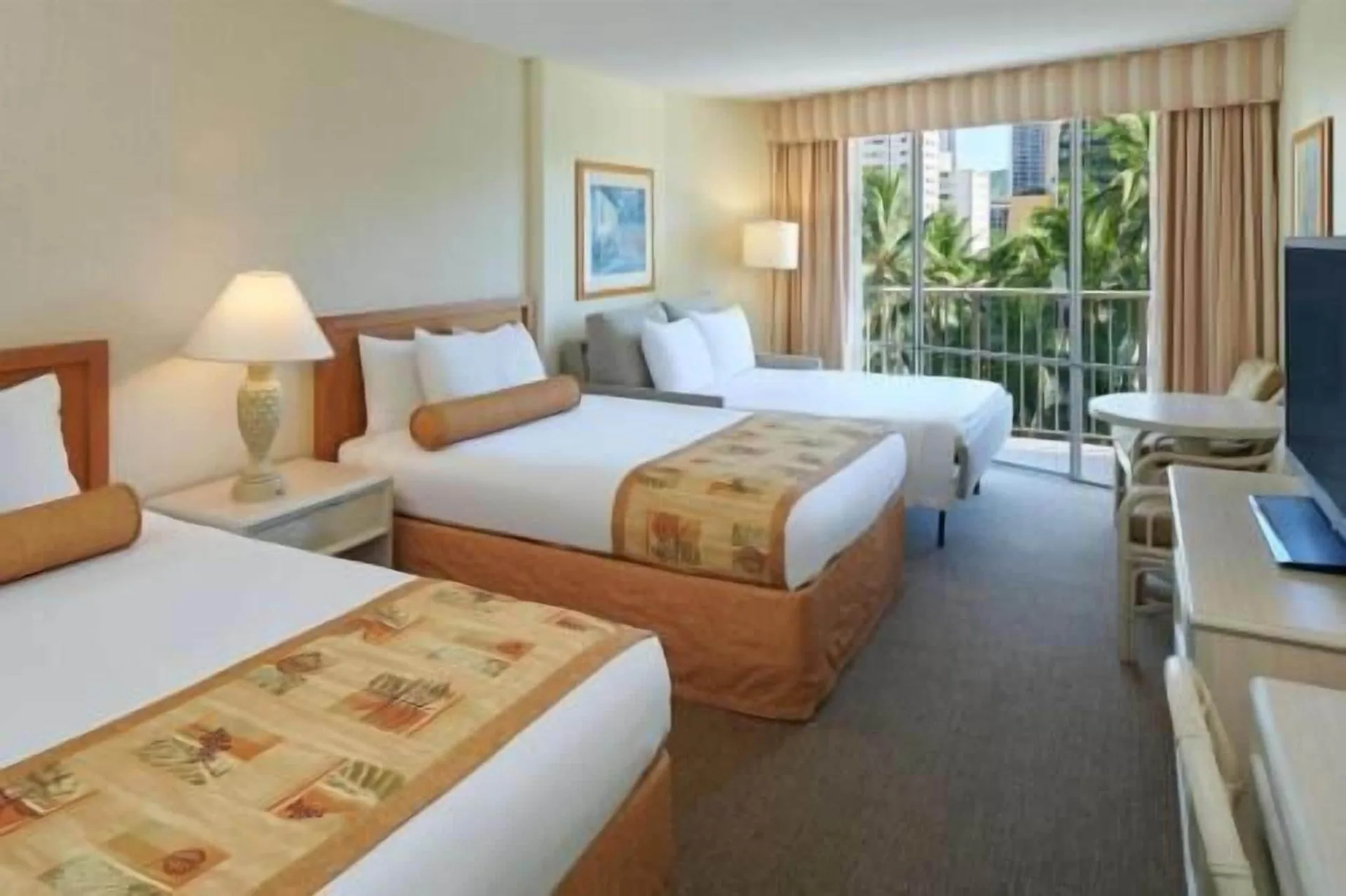 Waikiki Suite View room with three beds and balcony at OUTRIGGER Waikiki Paradise Hotel.