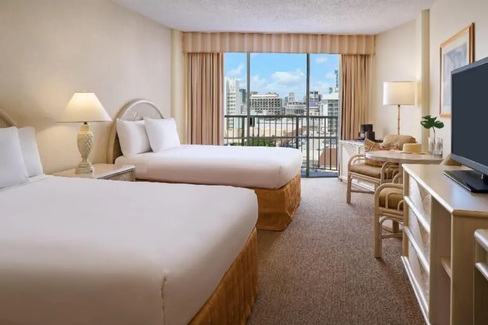 Waikiki Suite View room with two beds and city balcony at OUTRIGGER Waikiki Paradise Hotel.
