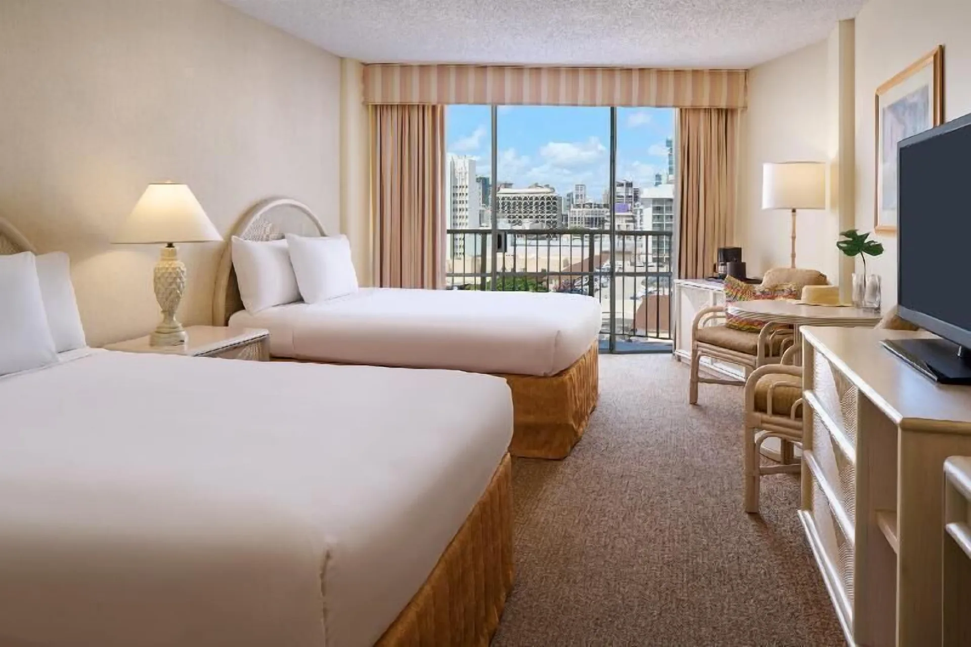 Waikiki Suite View room with two beds and city balcony at OUTRIGGER Waikiki Paradise Hotel.