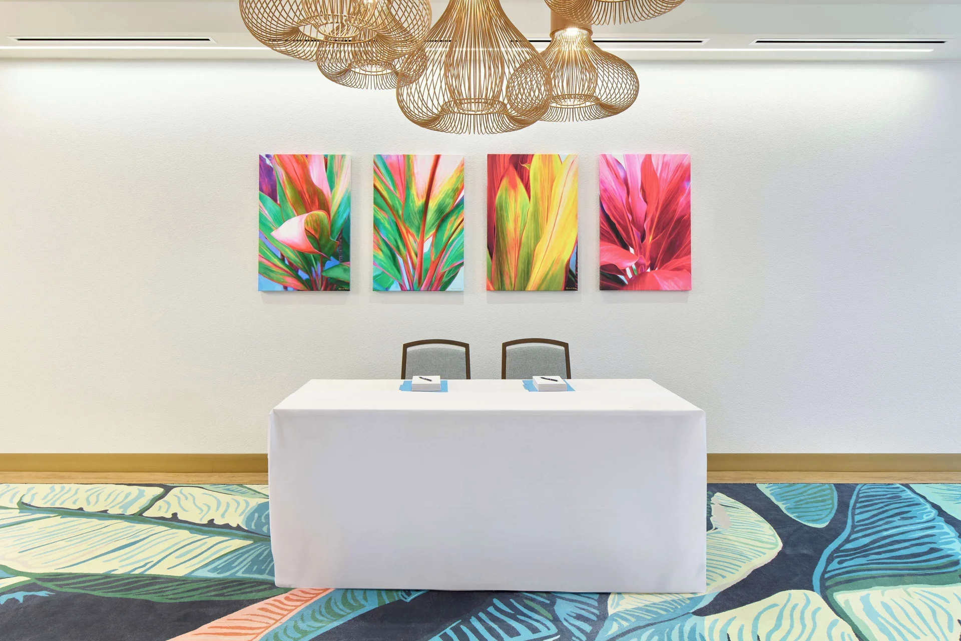 Registration table beneath floral artwork at OUTRIGGER Waikiki Paradise Hotel.