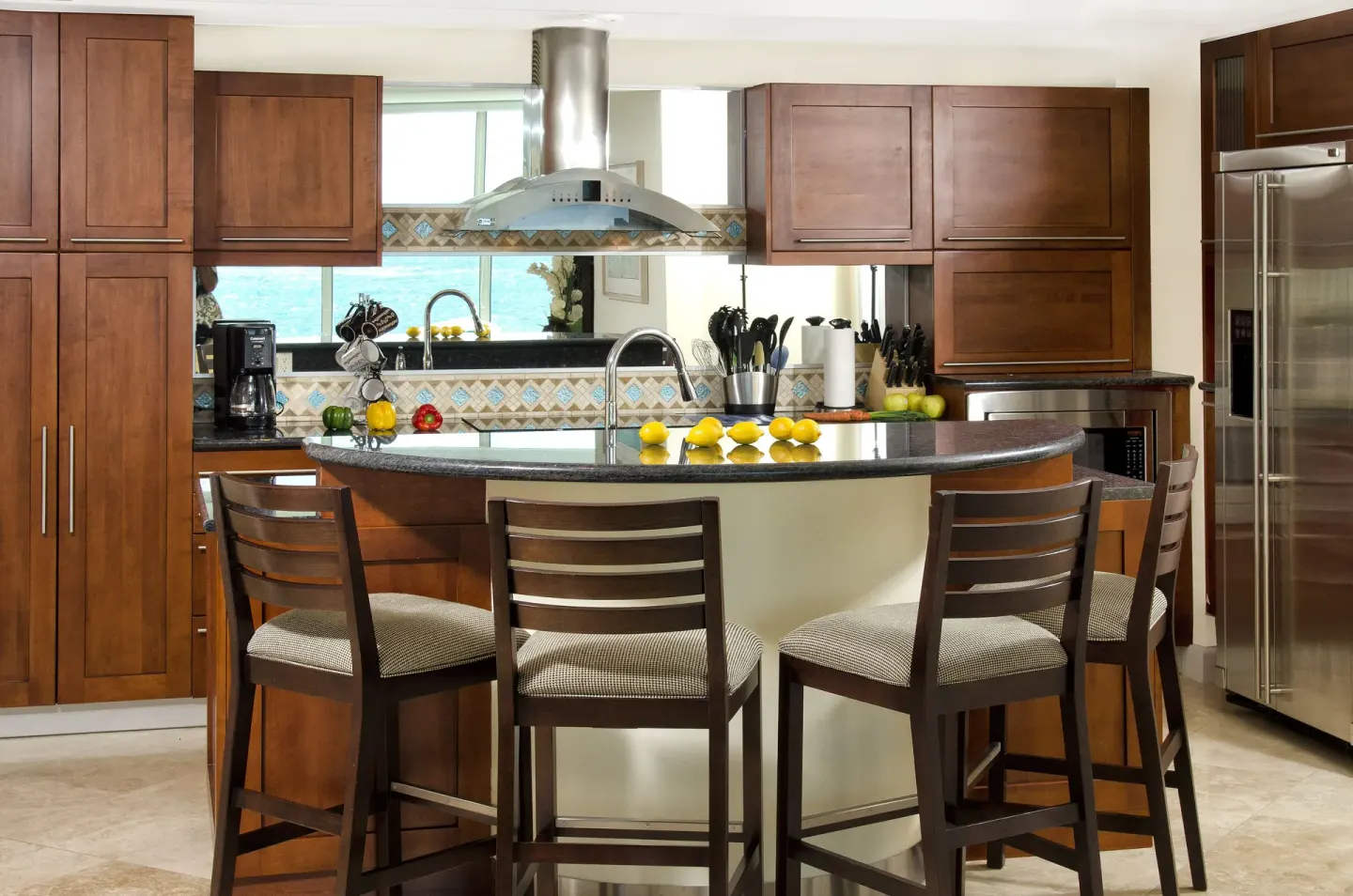 Kitchen with island seating and stainless appliances at Oyster Bay Beach Resort.