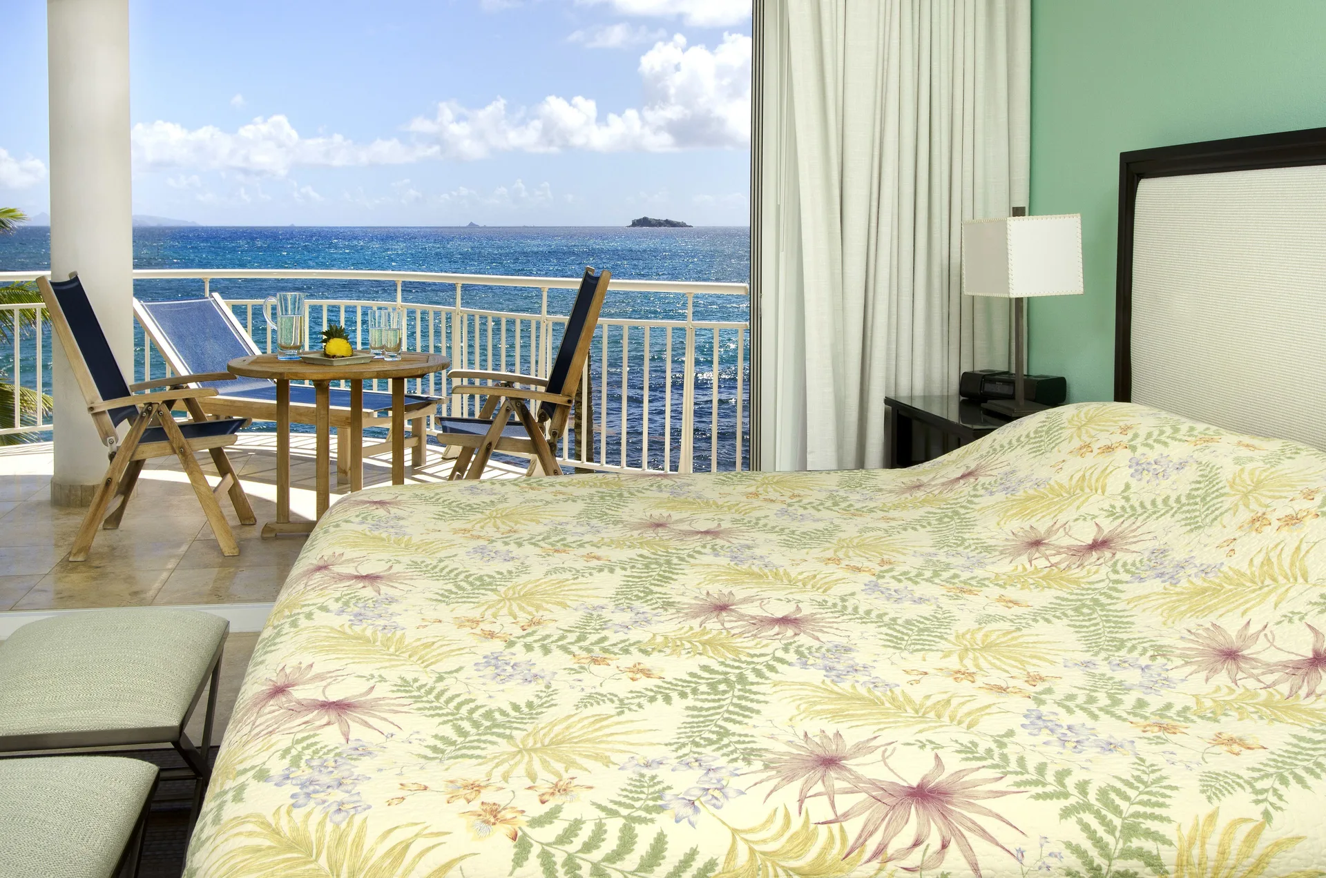 Bedroom with oceanfront balcony and king bed at Oyster Bay Beach Resort.