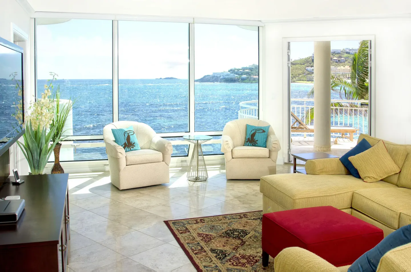 Oceanfront living room with large windows at Oyster Bay Beach Resort.