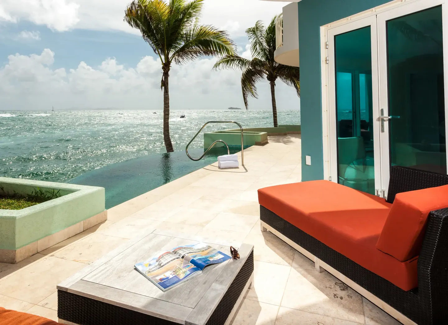 Oceanfront terrace with plunge pool and lounge seating at Oyster Bay Beach Resort.