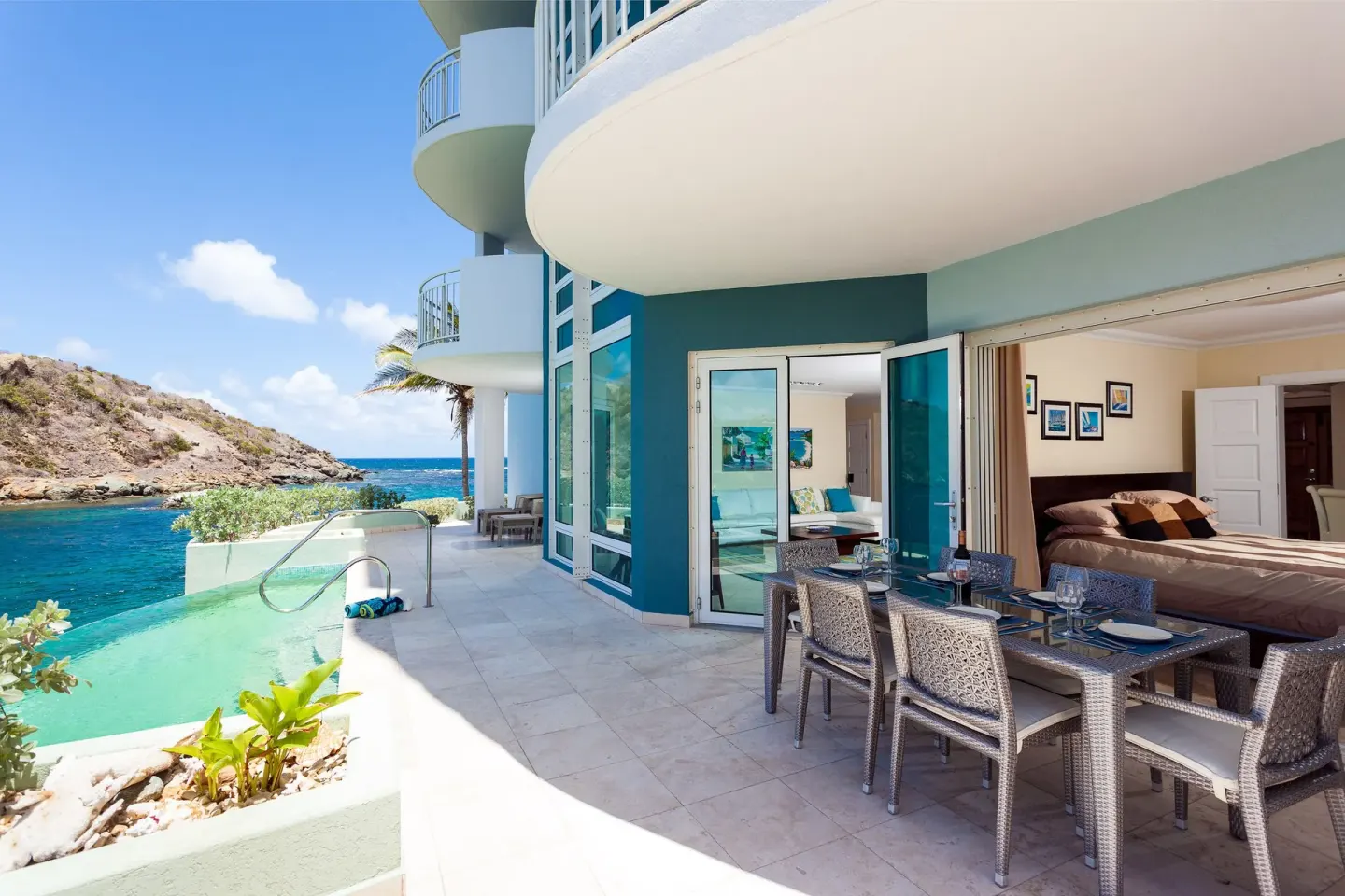 Oceanfront terrace with dining table and plunge pool at Oyster Bay Beach Resort.