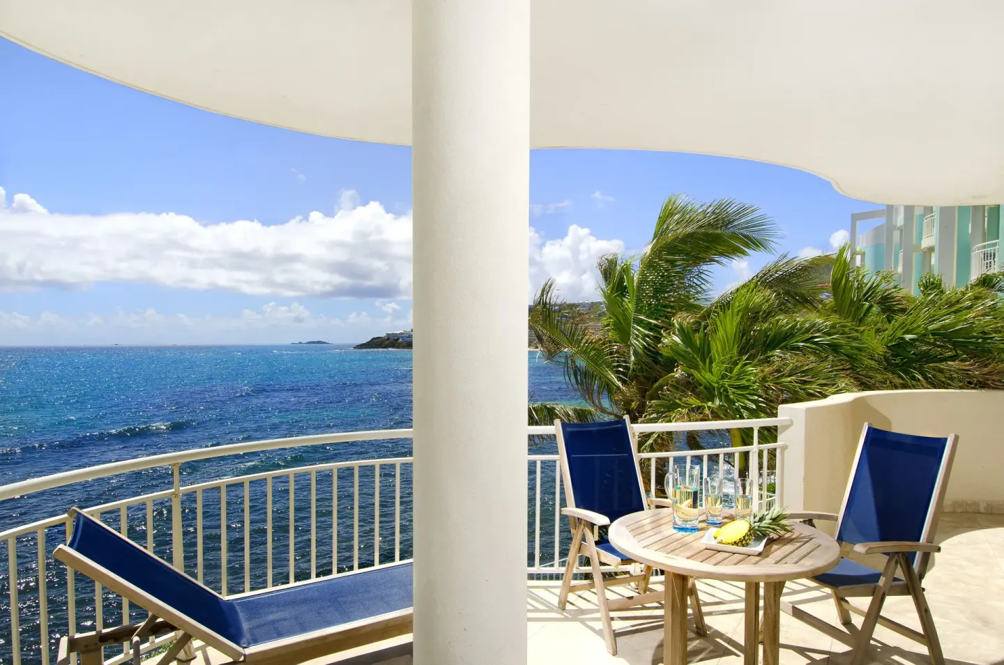 Oceanview balcony with lounge chairs at Oyster Bay Beach Resort.