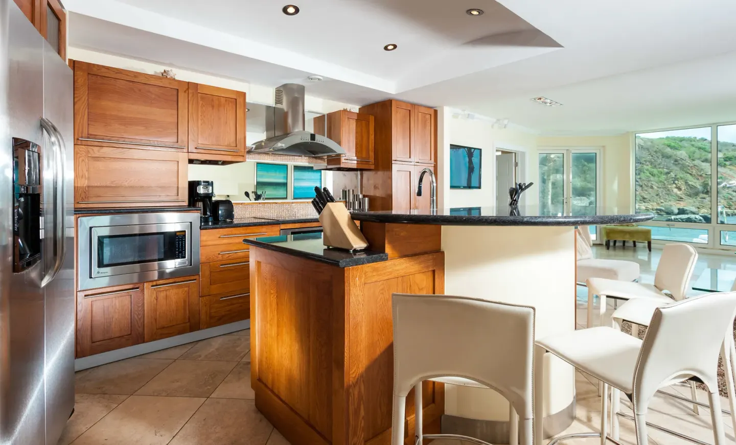 Full kitchen and dining counter in a suite at Oyster Bay Beach Resort.