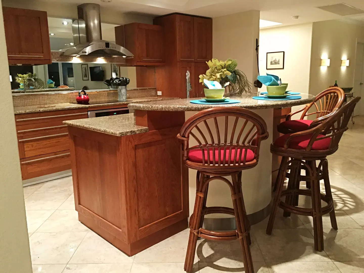 Kitchen island with rattan stools in a suite at Oyster Bay Beach Resort.