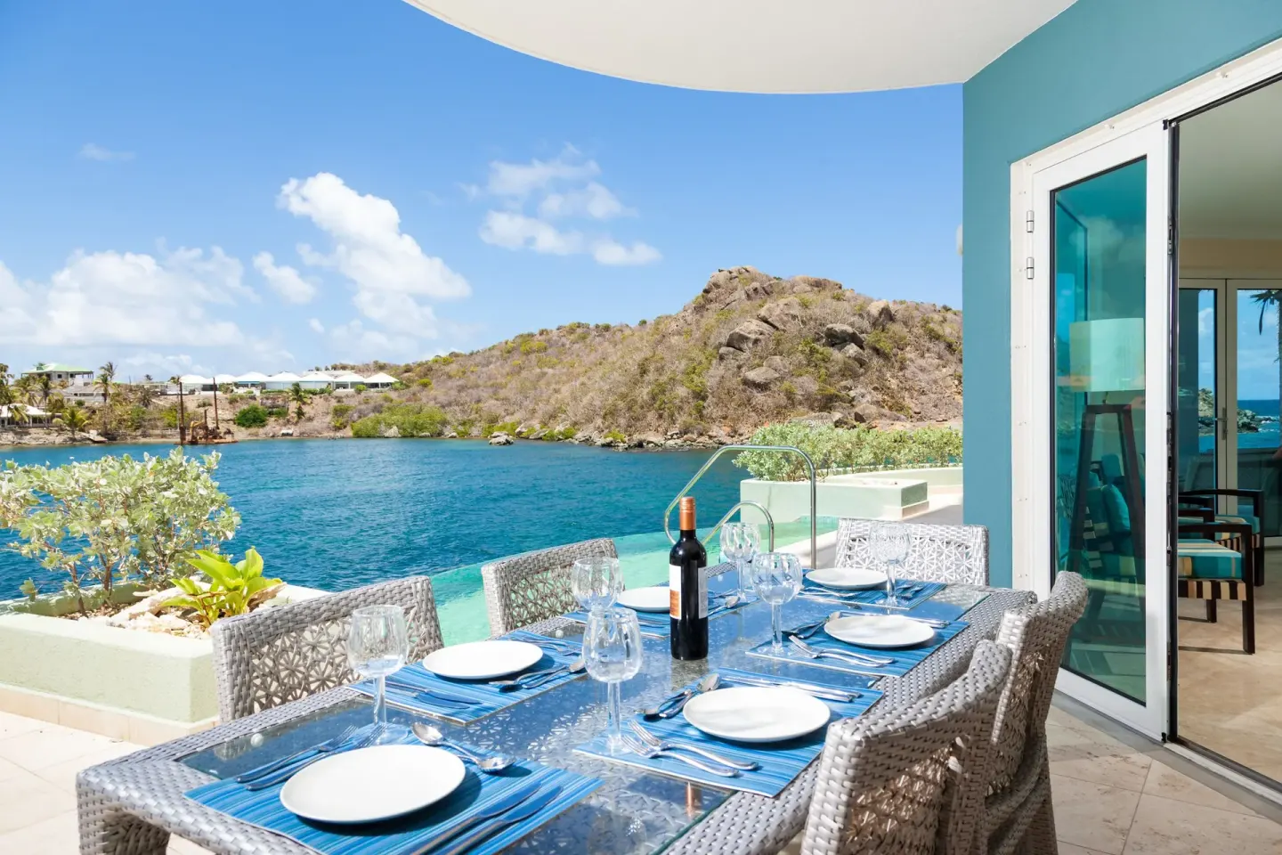 Terrace dining table overlooking the bay at Oyster Bay Beach Resort.