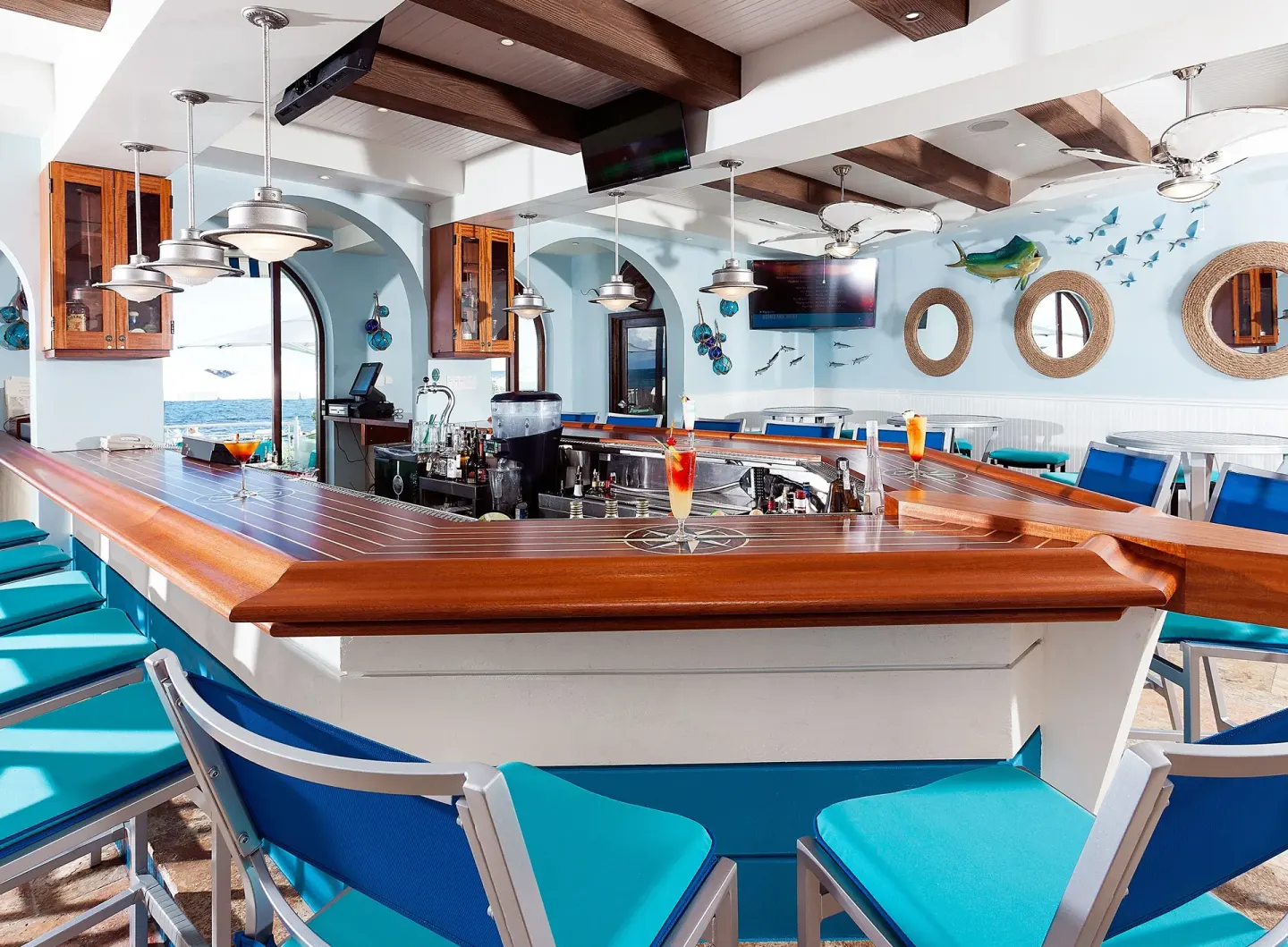 Nautical indoor bar with blue seating at Oyster Bay Beach Resort.