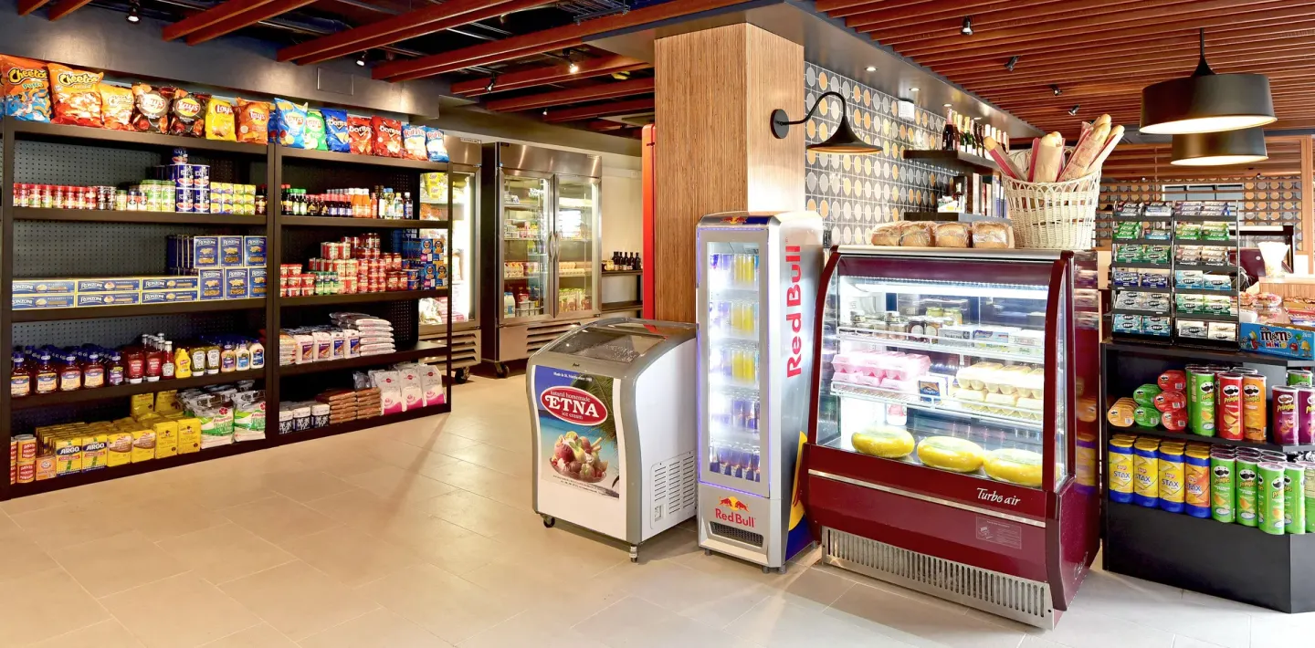 Market shelves and refrigerated cases at Oyster Bay Beach Resort.