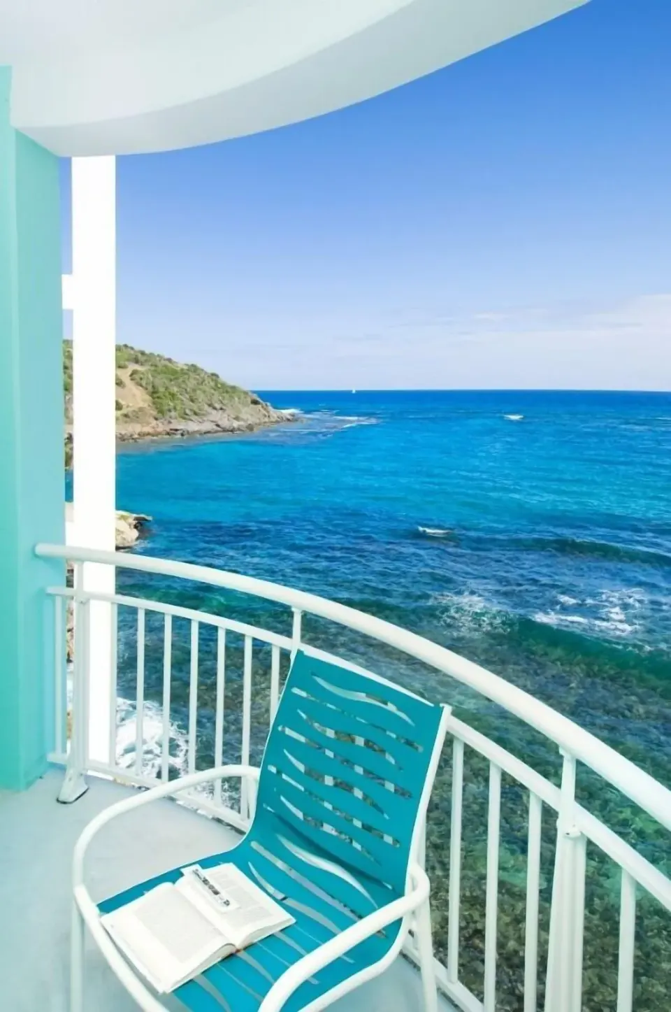 Penthouse 1 Bedroom Oceanfront balcony at Oyster Bay Beach Resort overlooking the blue Caribbean sea.