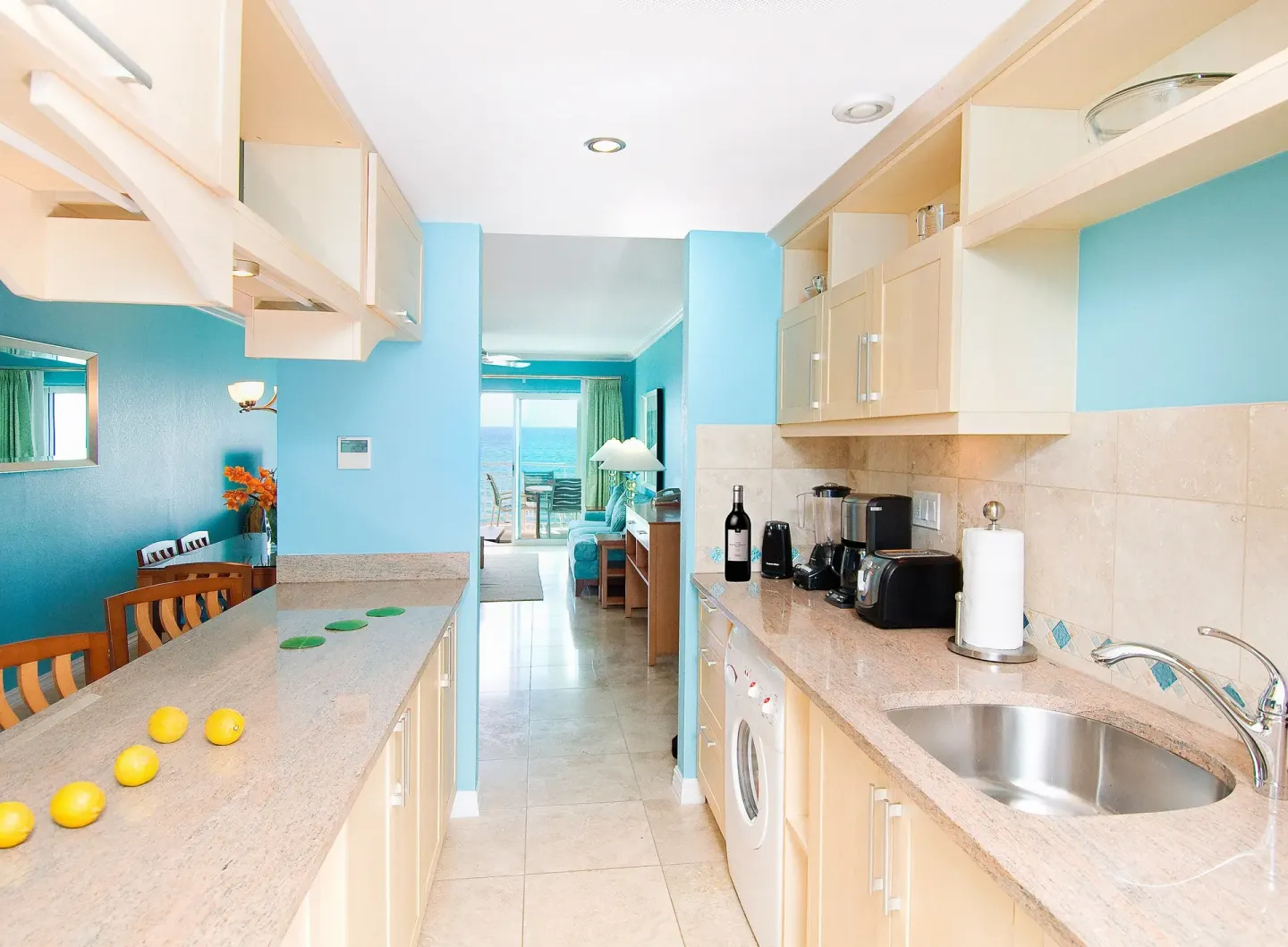 Penthouse 1 Bedroom Oceanfront kitchen at Oyster Bay Beach Resort with counters, sink and sea view beyond.