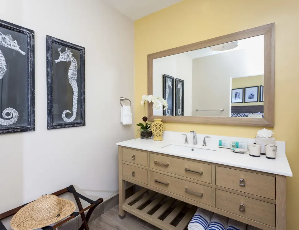 Premier Courtyard Room bathroom vanity with seahorse art at Oyster Bay Beach Resort.