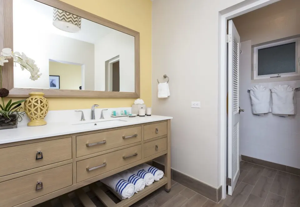 Premier Courtyard Room bathroom vanity and shower area at Oyster Bay Beach Resort.