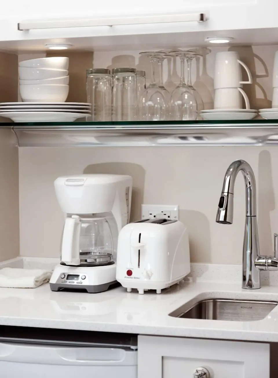 Premier Courtyard Room kitchenette sink and dishware at Oyster Bay Beach Resort.