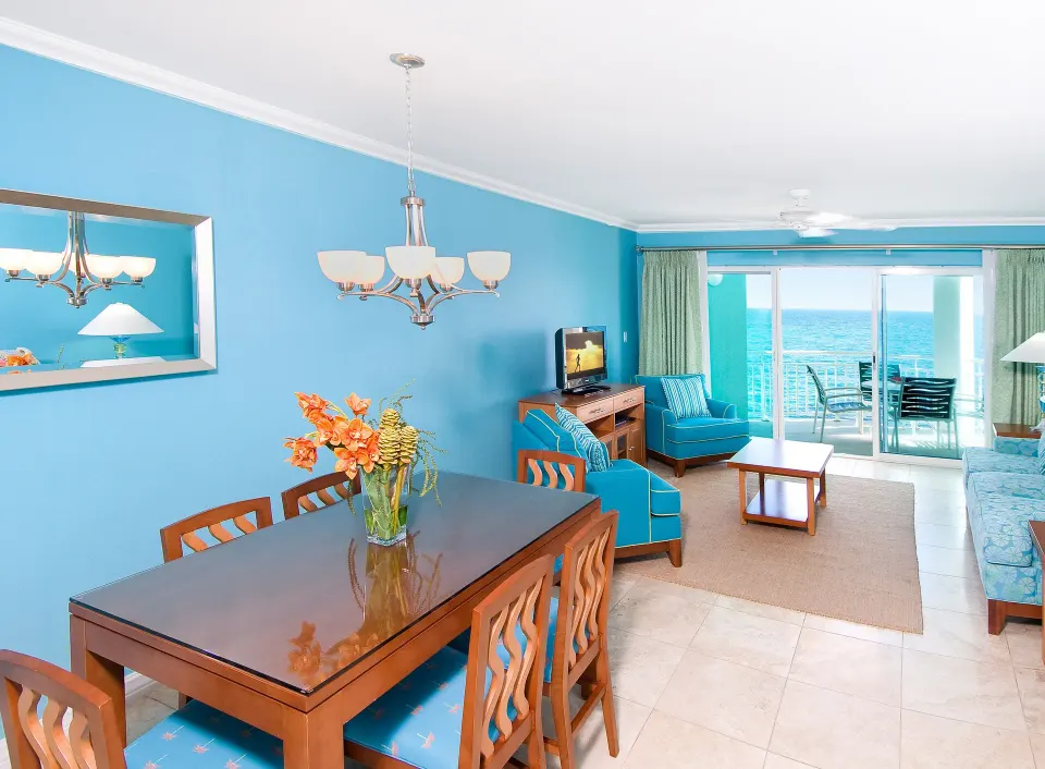 Oceanfront one-bedroom suite living and dining area at Oyster Bay Beach Resort.