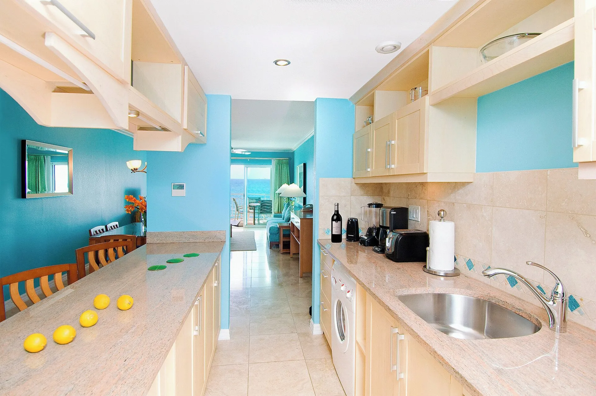 One-bedroom suite kitchen with dining counter at Oyster Bay Beach Resort.